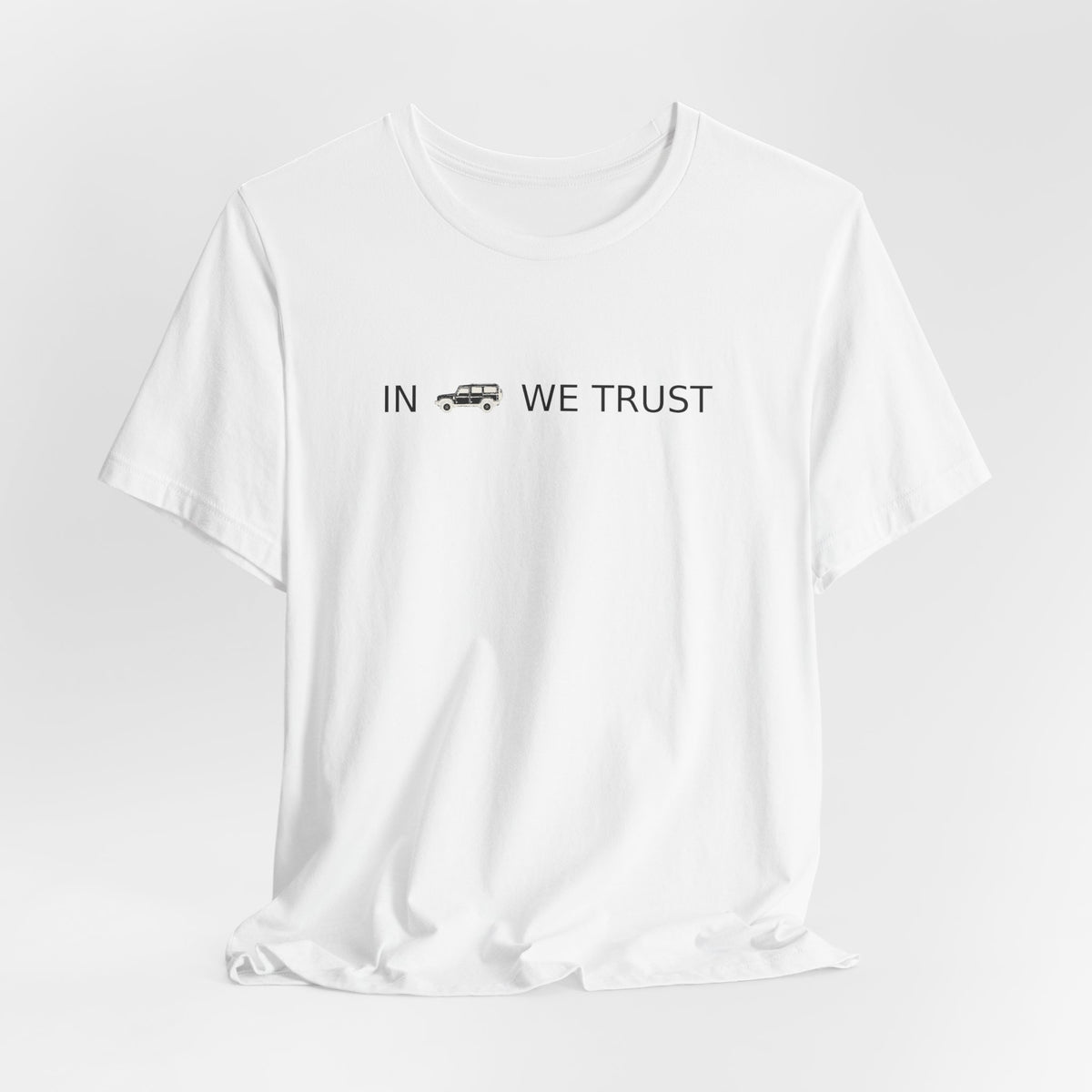 Tee with full-front IN WE TRUST lockup, side-view boxy 4x4 between the words – view 7