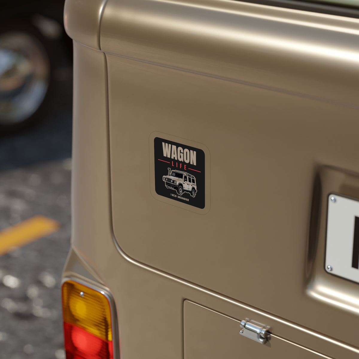 Wagon Life die-cut sticker: WAGON LIFE lettering over a white side-profile 4x4 wagon on a black badge – view 4