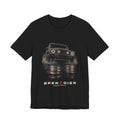 Black tee, front print: 4x4 wading dark water at night, headlights on (angled three-quarter view) with LIGHTS ON. WATER UP. lettering under GRENADIER wordmark, Black