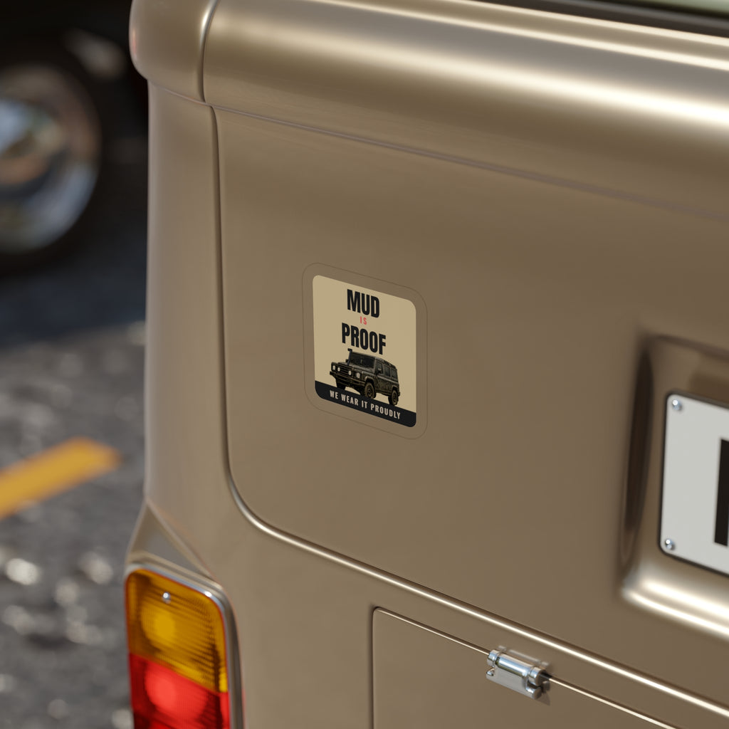 Mud Is Proof die-cut sticker: MUD IS PROOF lettering over a dark 4x4 wagon with a WE WEAR IT PROUDLY footer on a tan badge – view 4
