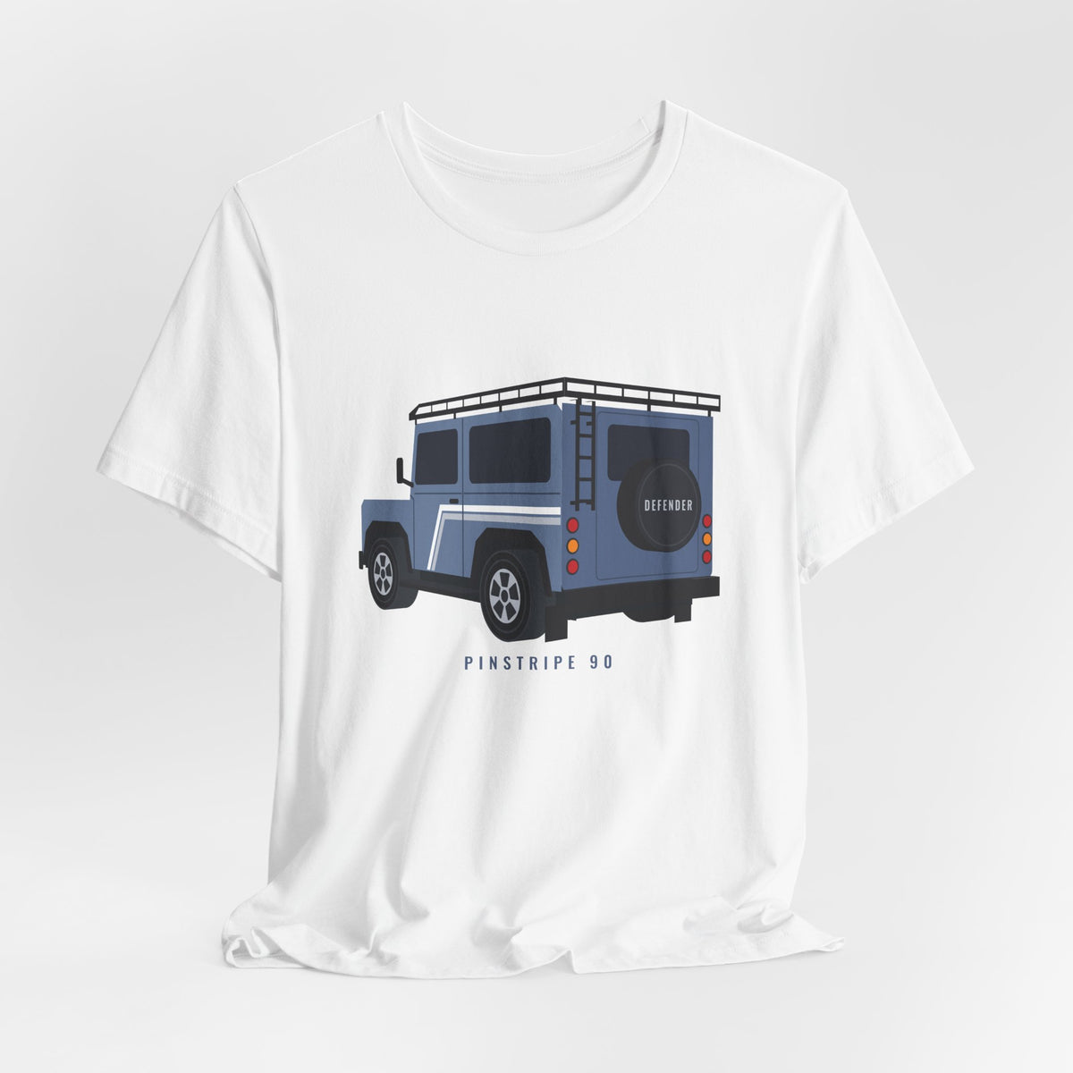 White tee, chest print: slate-blue boxy 90 4x4 in rear three-quarter view with pinstripes, roof rack, rear ladder; PINSTRIPE 90 lettering – view 3