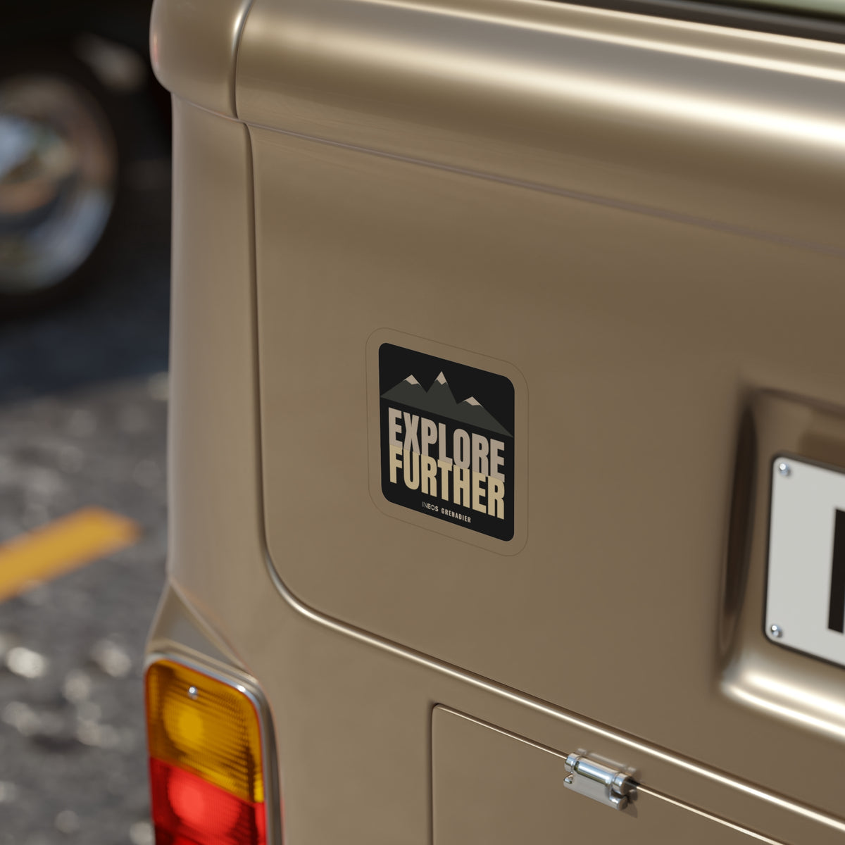 Explore Further die-cut sticker: mountain peaks above big EXPLORE FURTHER lettering in cream and tan on a black badge – view 6