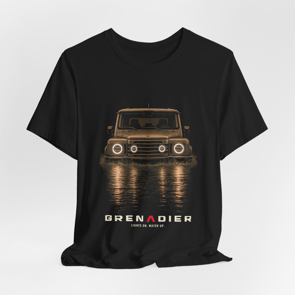 Black tee, front print: 4x4 wading dark water at night, headlights on (warm sepia tones) with LIGHTS ON. WATER UP. lettering under GRENADIER wordmark – view 3