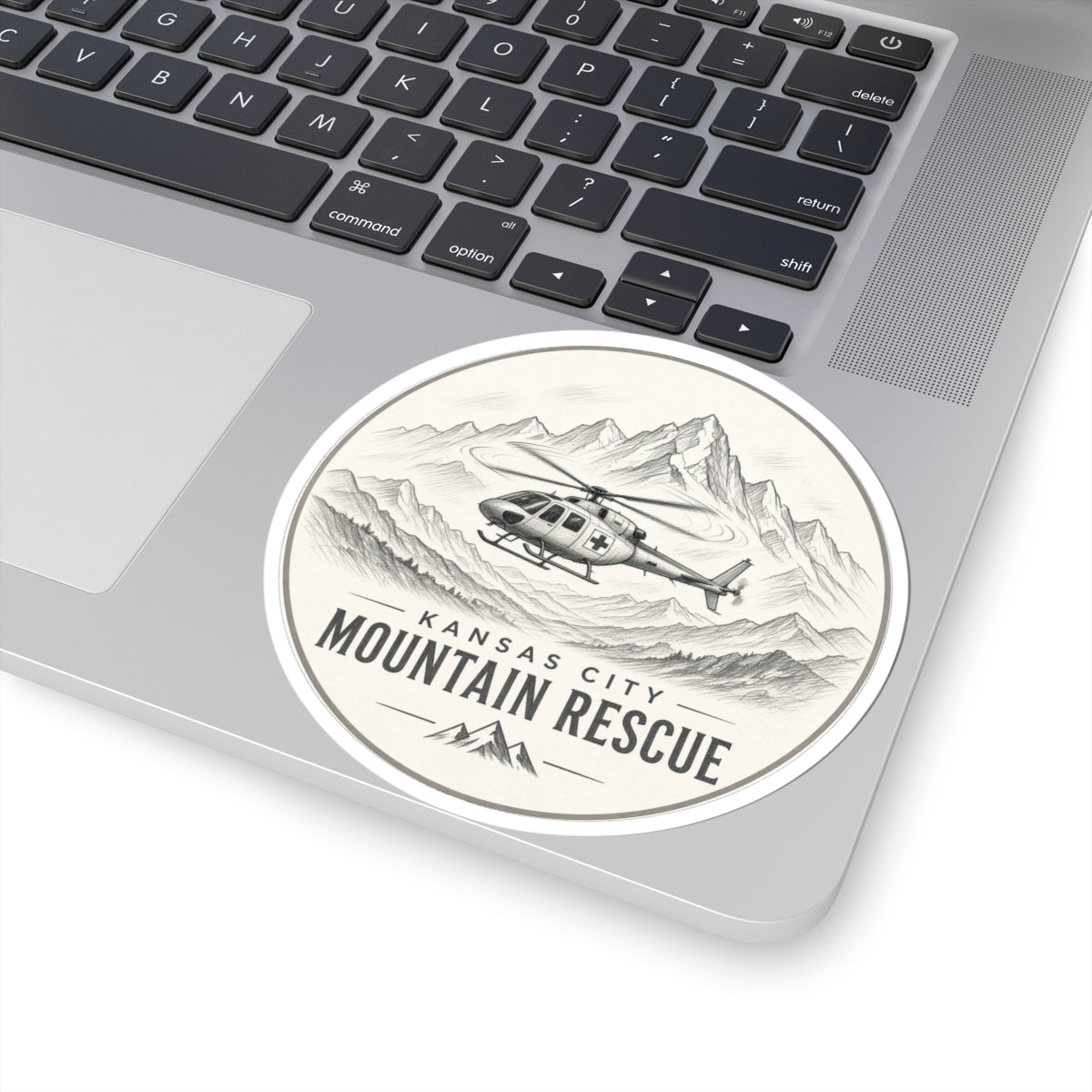 Round sticker: Kansas City Mountain Rescue, helicopter flying past sketched mountain range – view 5
