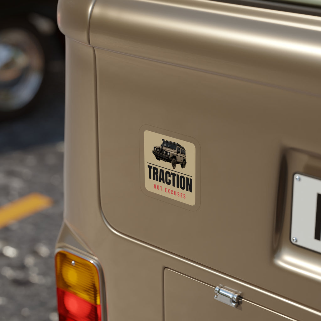 Traction Not Excuses die-cut sticker: a 4x4 wagon above bold TRACTION lettering and a red NOT EXCUSES line on a tan badge – view 6