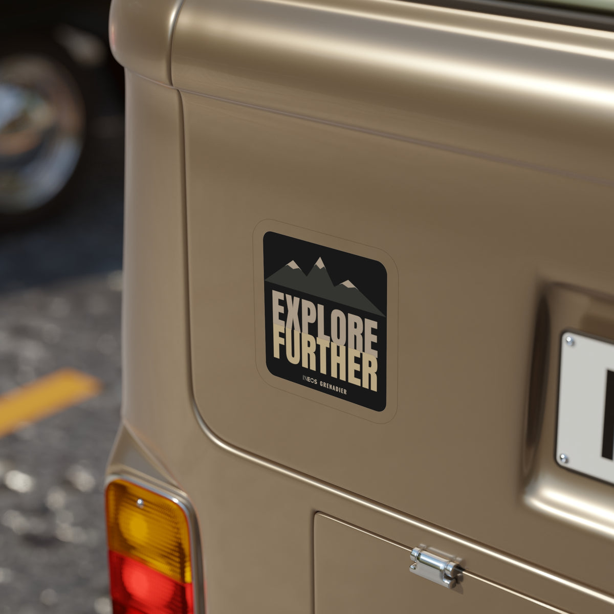 Explore Further die-cut sticker: mountain peaks above big EXPLORE FURTHER lettering in cream and tan on a black badge – view 8
