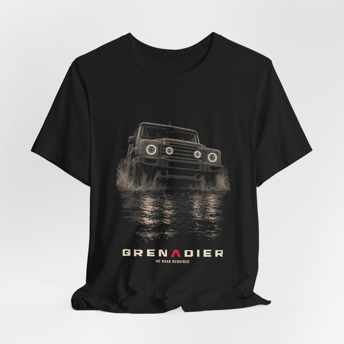 Black tee, front print: 4x4 wading dark water at night, headlights on (angled three-quarter view) with NO ROAD REQUIRED lettering under GRENADIER wordmark – view 3