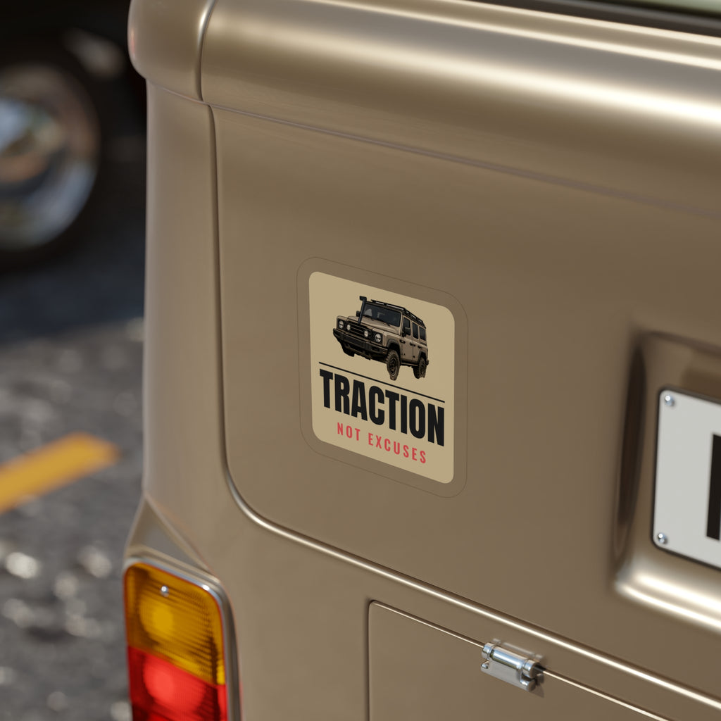 Traction Not Excuses die-cut sticker: a 4x4 wagon above bold TRACTION lettering and a red NOT EXCUSES line on a tan badge – view 8