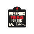 Weekends Were Made for This die-cut sticker: a campfire-topped badge with WEEKENDS WERE MADE FOR THIS lettering over a tent, pines and a 4x4 wagon