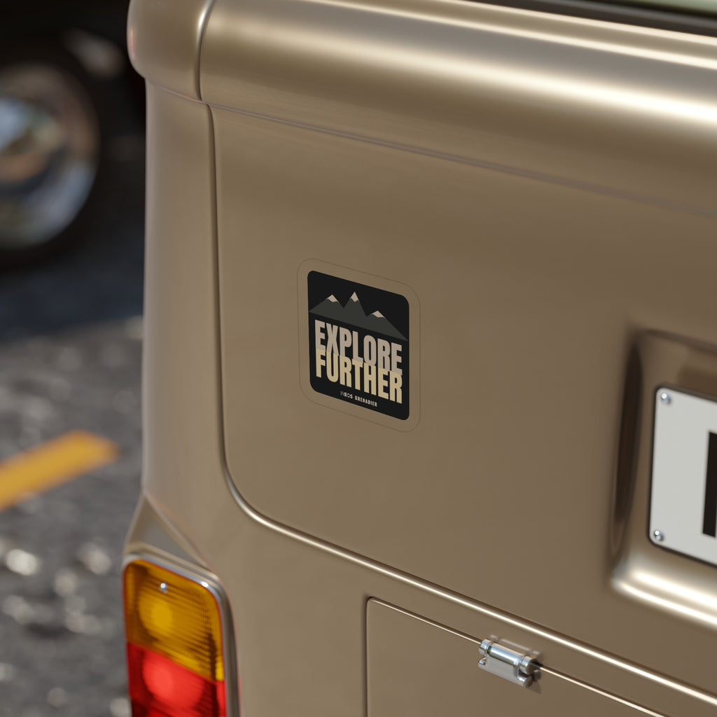 Explore Further die-cut sticker: mountain peaks above big EXPLORE FURTHER lettering in cream and tan on a black badge – view 4