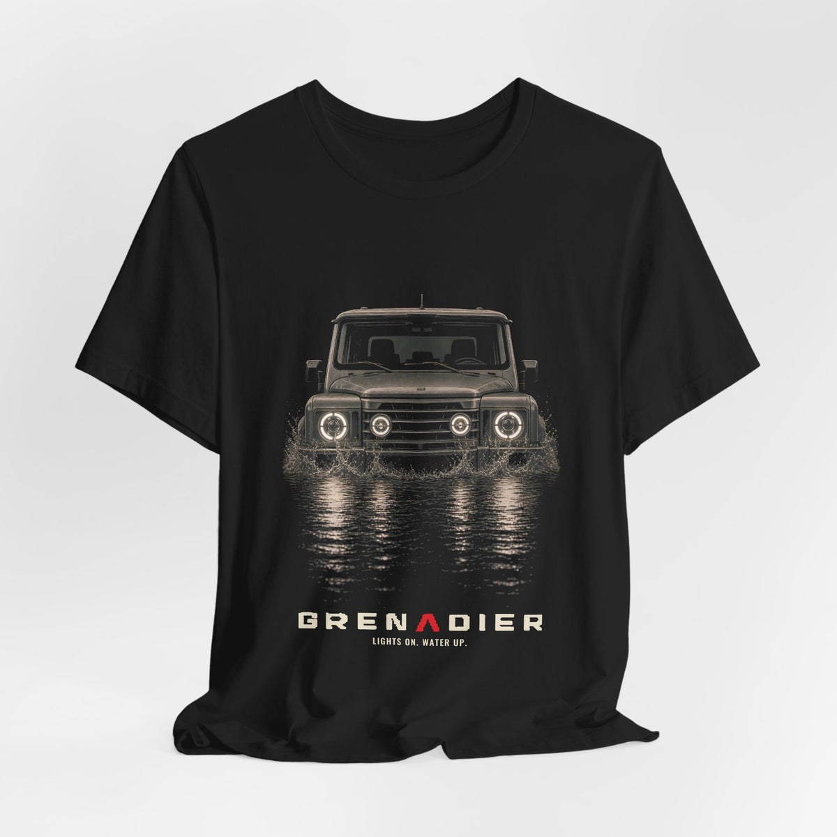 Black tee, front print: 4x4 wading dark water at night, headlights on (splash of water across the bow) with LIGHTS ON. WATER UP. lettering under GRENADIER wordmark – view 3