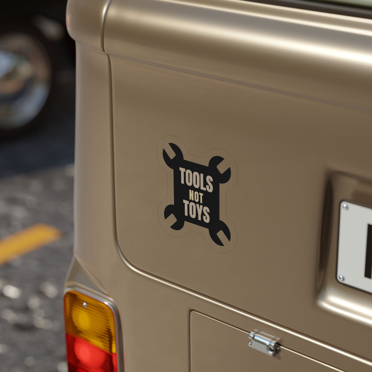 Tools Not Toys die-cut sticker: TOOLS NOT TOYS lettering on a black crossed-wrench shape – view 8