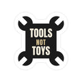 Tools Not Toys die-cut sticker: TOOLS NOT TOYS lettering on a black crossed-wrench shape