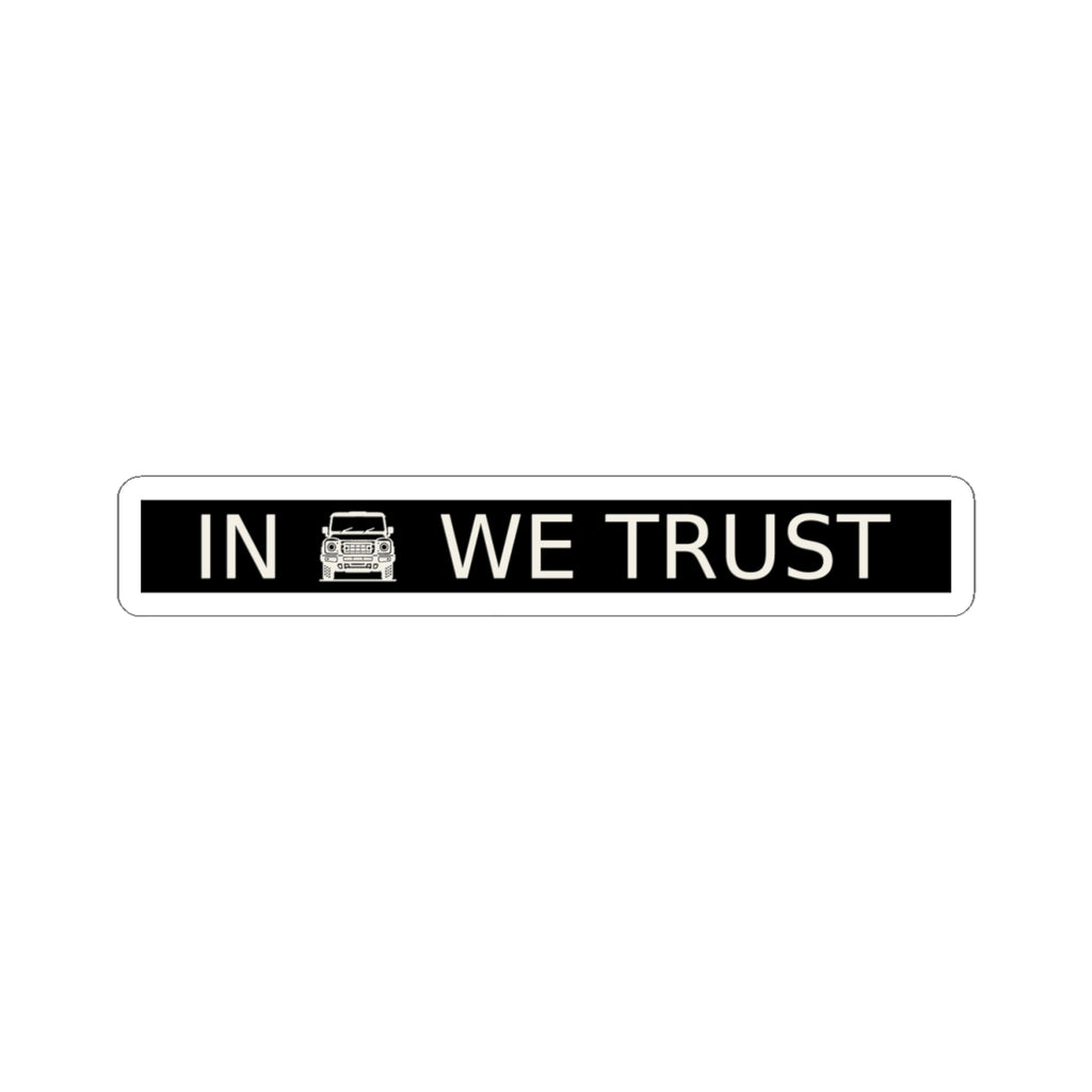 Black rectangular plate sticker reading IN WE TRUST with front-view boxy 4x4