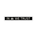 Black rectangular plate sticker reading IN WE TRUST with front-view boxy 4x4