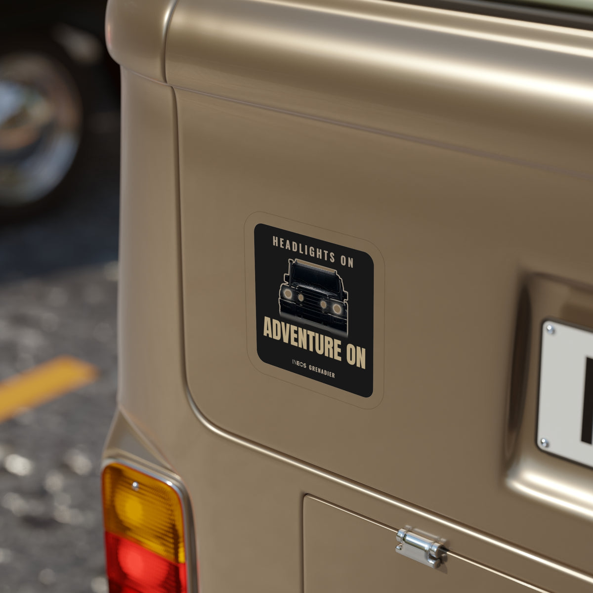 Headlights On / Adventure On die-cut sticker: a head-on 4x4 with glowing headlights between HEADLIGHTS ON and ADVENTURE ON lettering on black – view 8